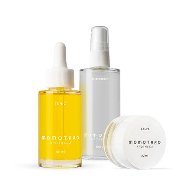 Three glass botltes and jars of Momotaro Apotheca yellow Tonic, Hydrosol and Salve Nudie Co