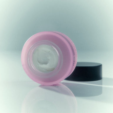 Open purple glass pot of soothing anal cream with black lid Nudie Co