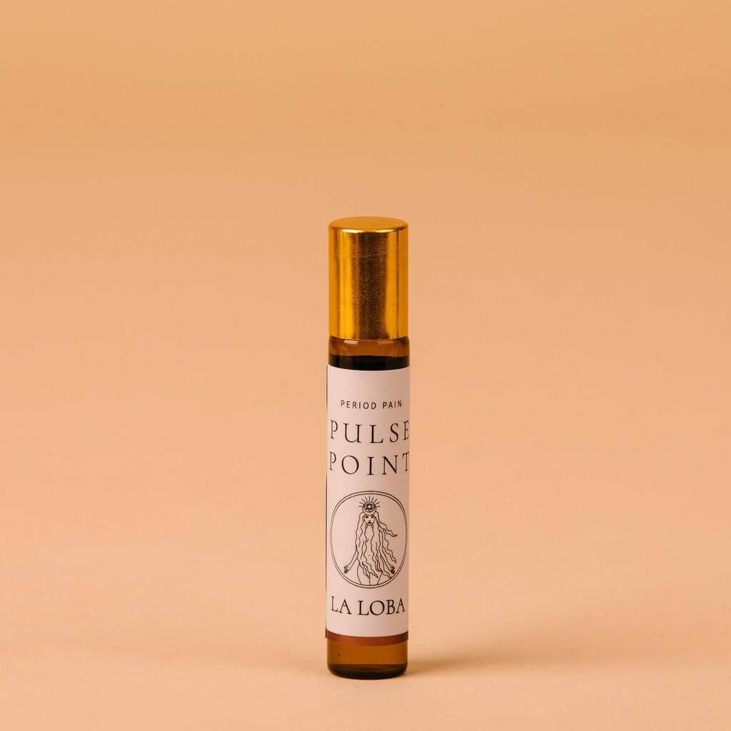 Small brown glass bottle oil applicator for pulse points with golden cap to treat period pains Nudie Co