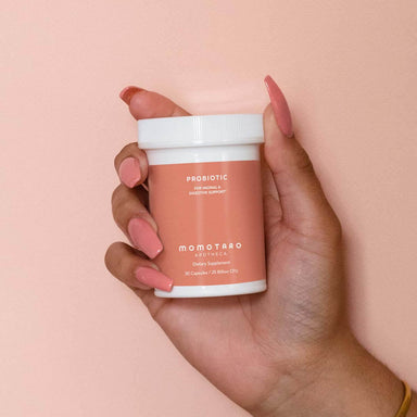 White box of probiotic in woman's hand Nudie Co