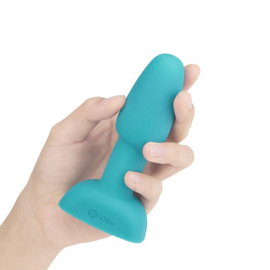 Hand holding blue silicone butt plug Nudie Co