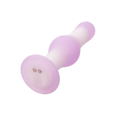 Purple and white silicone butt plug on a white background with charging pins at bottom Nudie Co