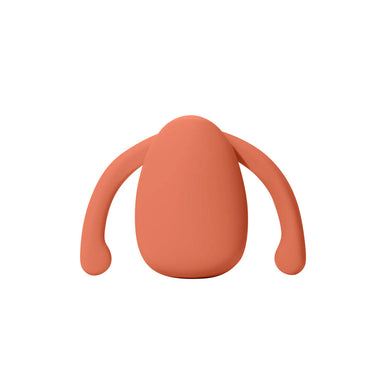 Orange silicone vibrator for clitoris with two wings on the side to nest inside labia Nudie Co