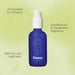 Blue bottle of massage oil with white pump over a green background  Nudie Co