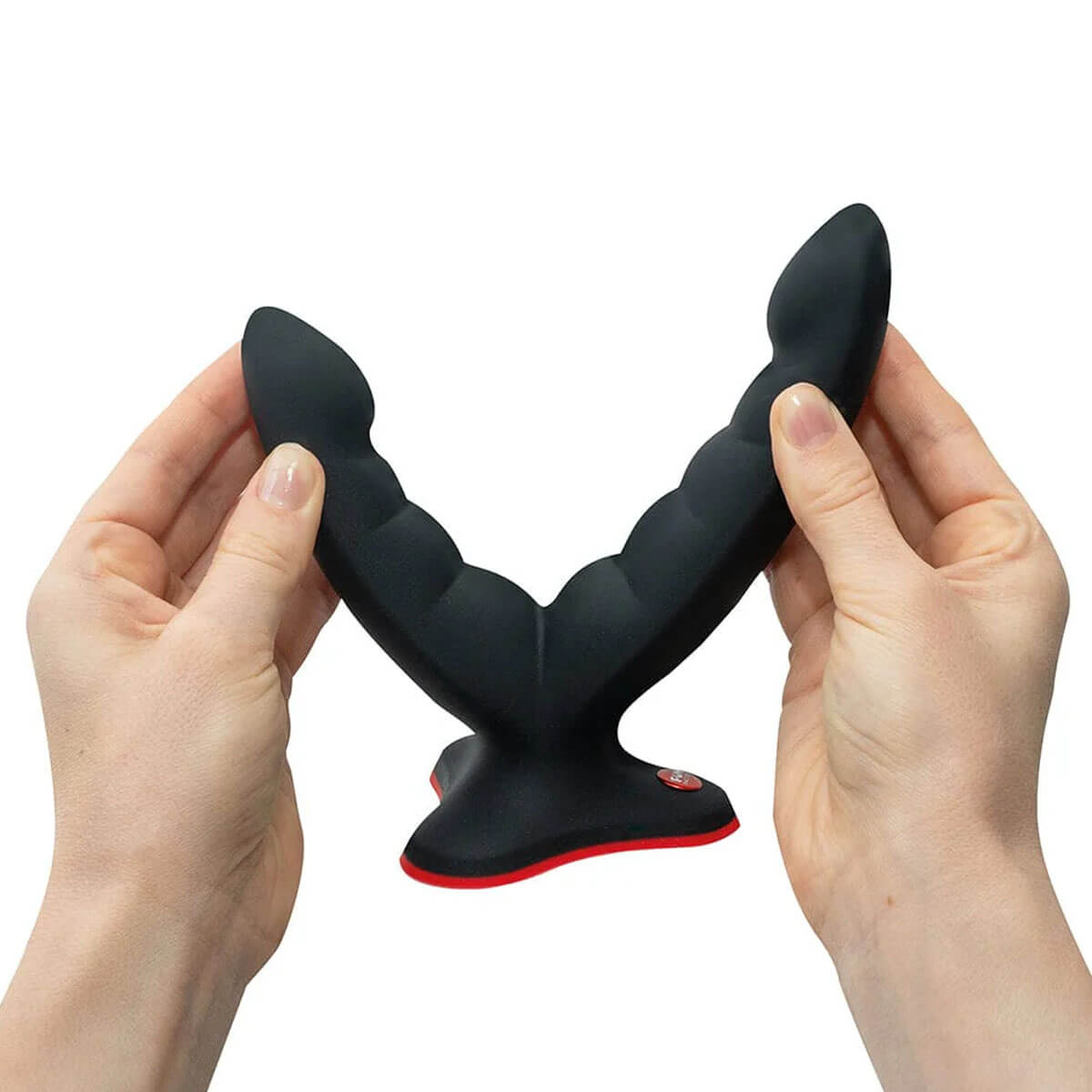 Hands holding a black silicone grinding dildo with two ribbed shafts Nudie Co