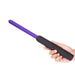 Hand holding a purple and black handheld electro play device on a white background Nudie Co