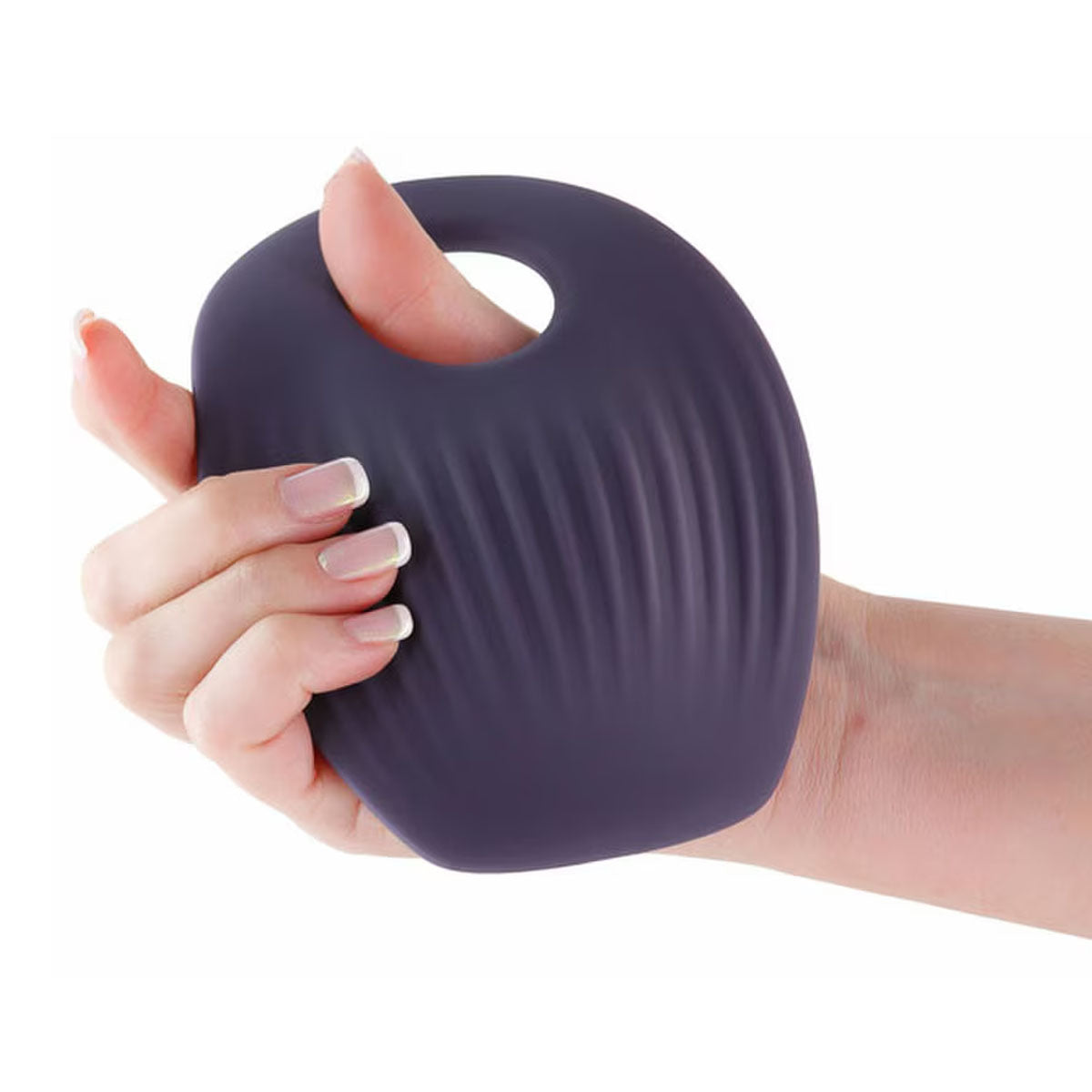 Woman's hand holding a grey silicone grinding pad with a hole to insert a dildo Nudie Co