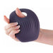 Woman's hand holding a grey silicone grinding pad with a hole to insert a dildo Nudie Co