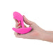 Hand holding a pink silicone internal vibrator for G-spot stimulation Nudie Co