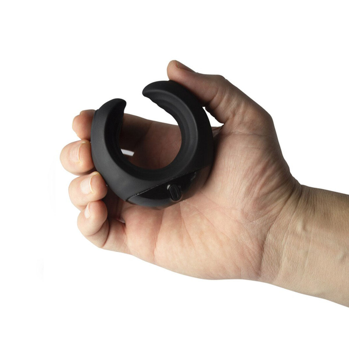 Hand holding a black silicone vibrating cock ring on a white background Nudie Co