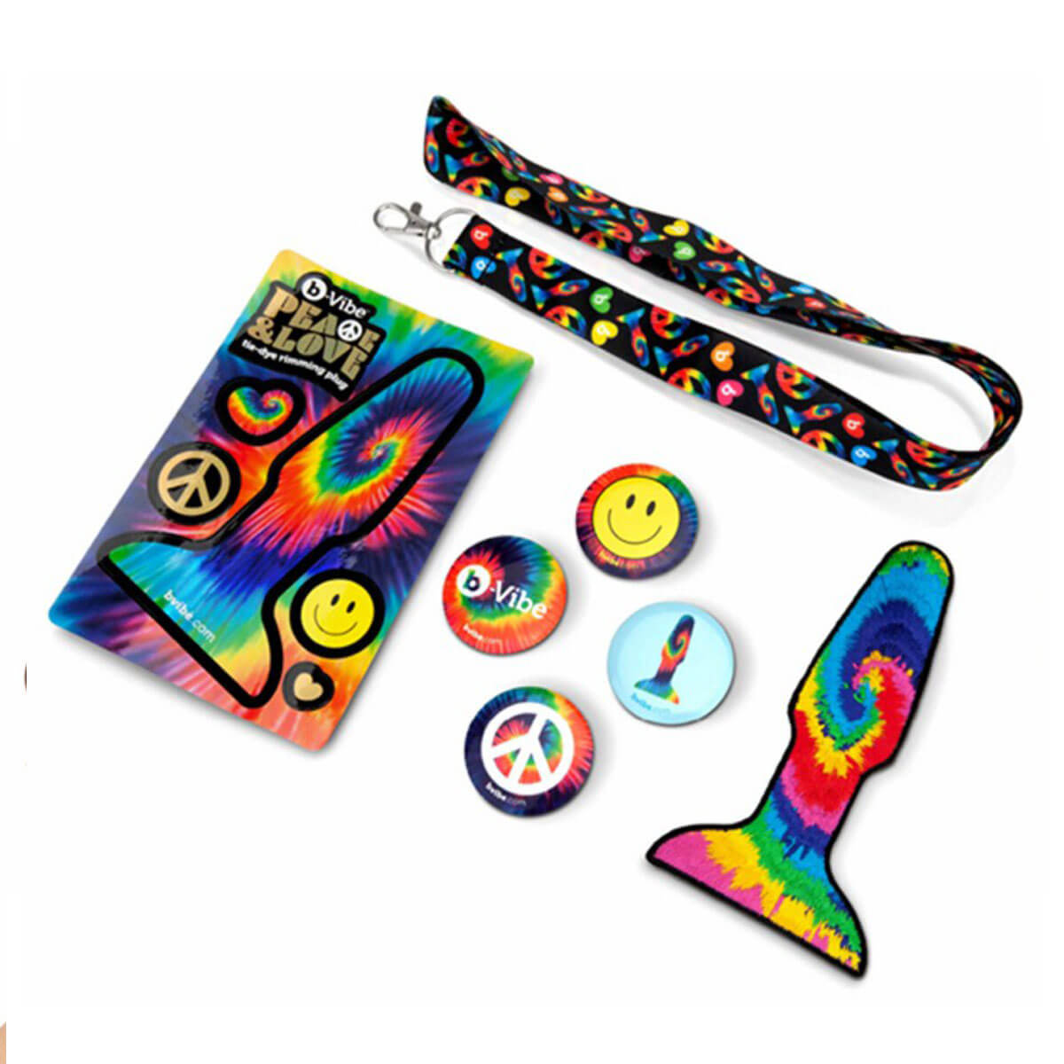 Colorful tie-dye accessories including a lanyard, badge holder, and buttons on a white background. Nudie Co