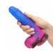 Hand holding a ombre blue and pink silicone dildo with suction cup Nudie Co