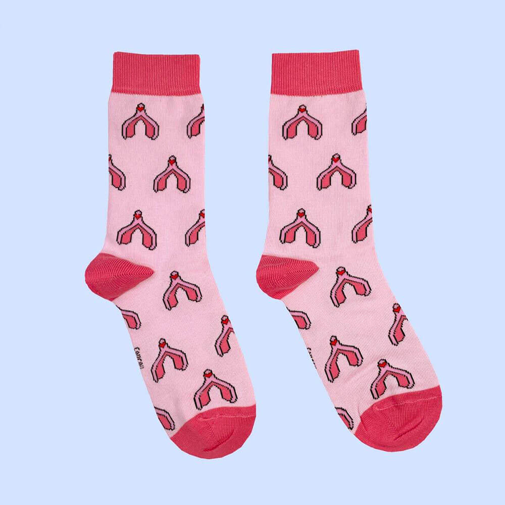 Pink cotton socks with a clitoris print over a blue background Nudie Co