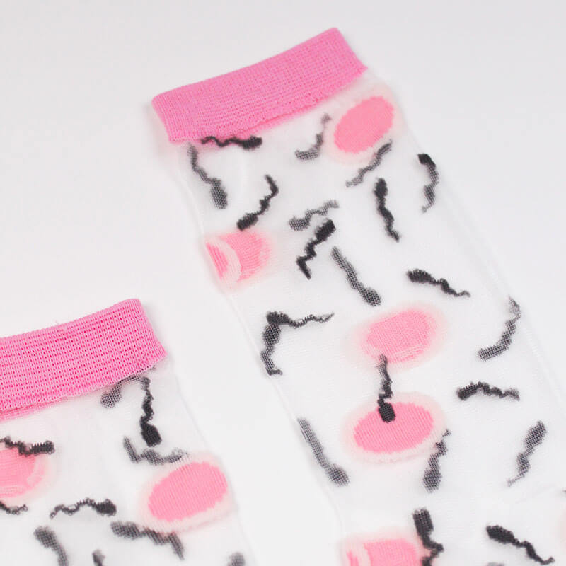 Close-up of sheer sock printed with spermatozoids and ovules Nudie Co