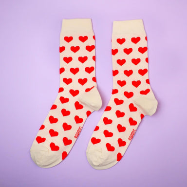 Cream cotton socks with red heart print over a purple background Nudie Co