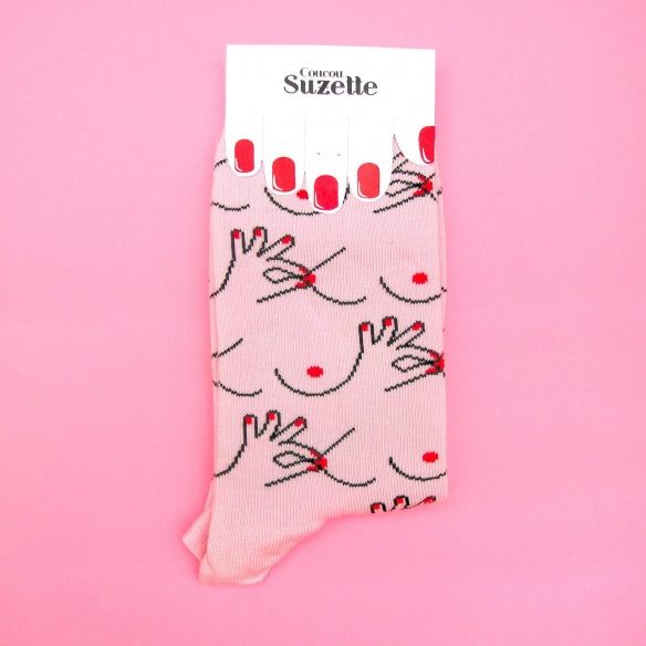 Packaged folded pink socks with boob and nipple print Nudie Co