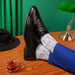 Man wearing blue pants and black shoes with blue cotton socks and penis pattern Nudie Co