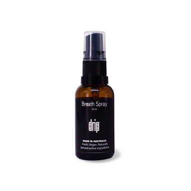 Black spray bottle of vegan breath spray, with black and white label Nudie Co