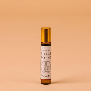 Small brown glass bottle oil applicator for pulse points with golden cap to treat period pains Nudie Co