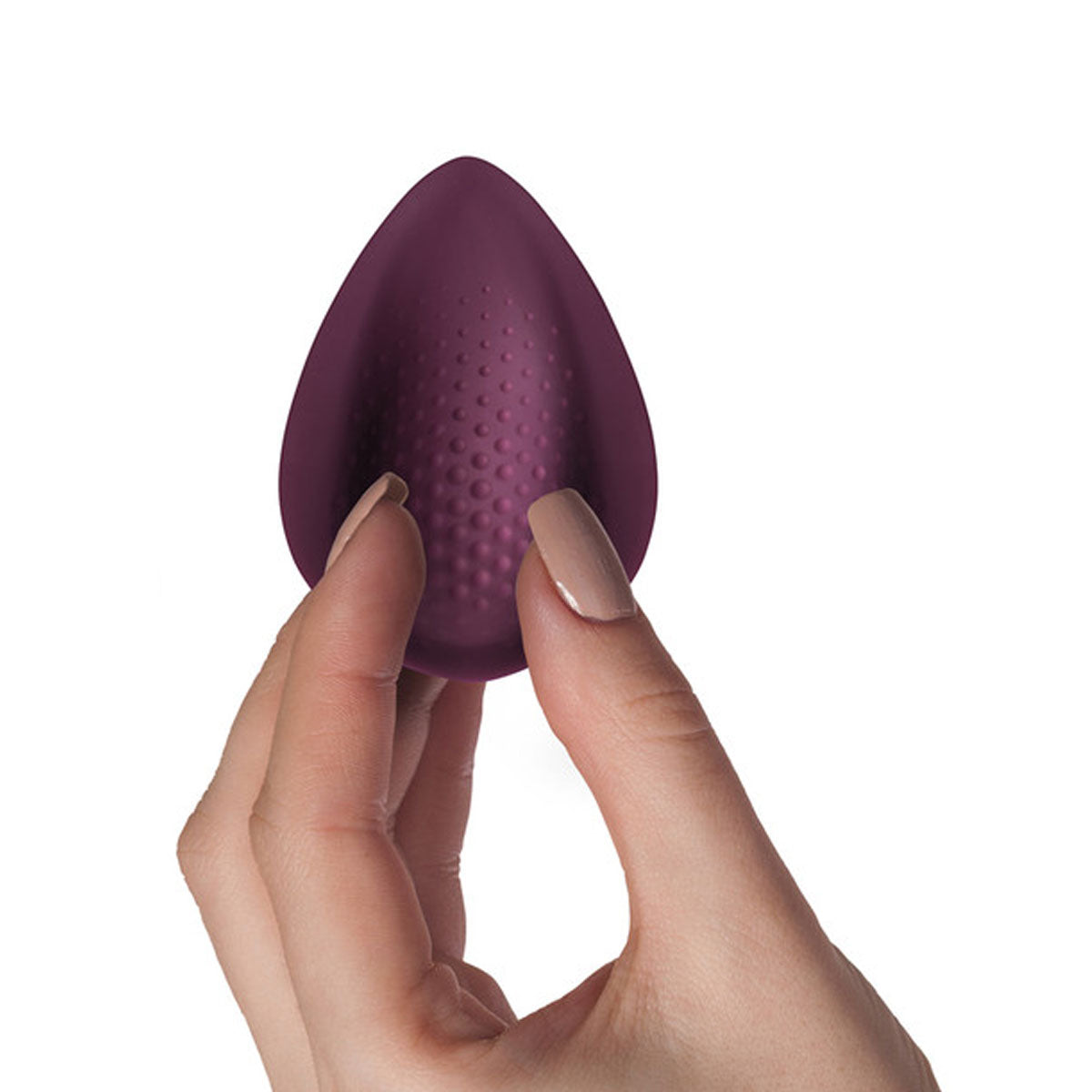 Hand holding small burgundy vibrator with bumpy texture Nudie Co