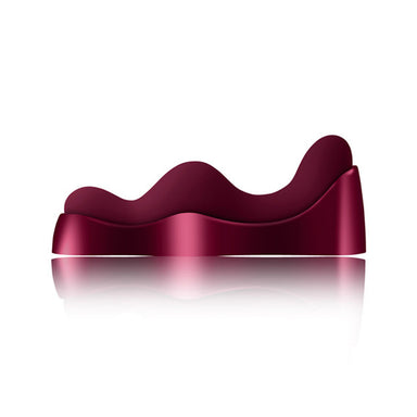 Burgundy wavy silicone vibrator on a metal charging dock Nudie Co