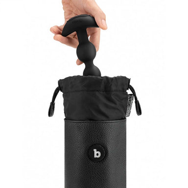 Hand placing a black butt plug inside a black UV sterilising pouch Nudie Co