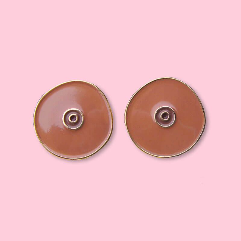 Front view of two black boob-shaped pins Nudie Co