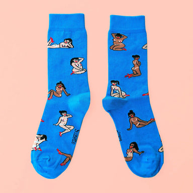 Flat view of two blue socks printed with girls Nudie Co